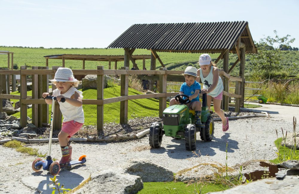 3 children racing around the Balance Bike Track at Tredethick