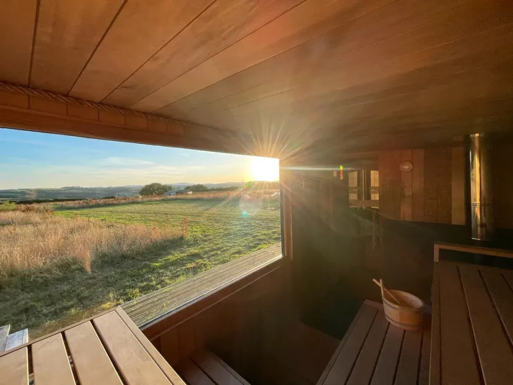 Sunset over the Cornish countryside viewed from the wooden sauna at Earthbound Farm.