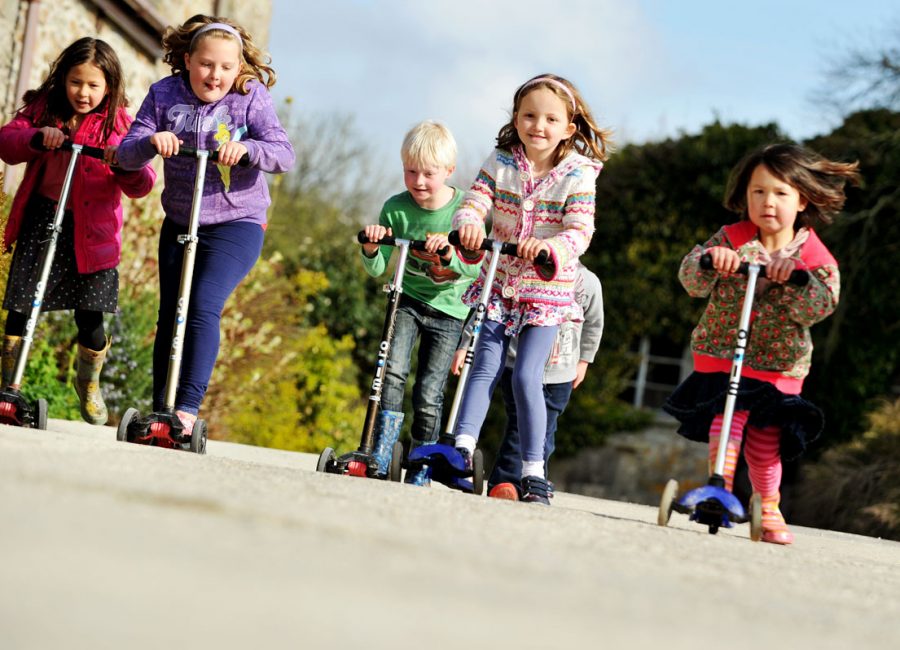Group of young children on scooters