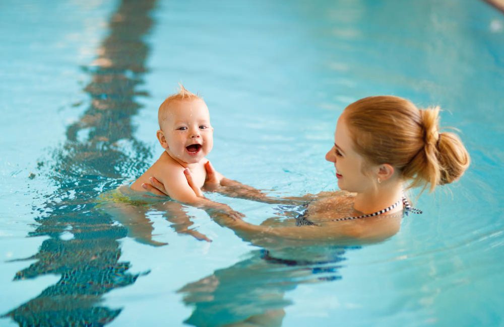 Mother and baby swim  in the pool