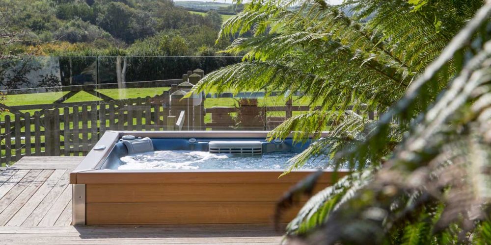 Hottub built into the decking at a holiday cottage at Tredethick.