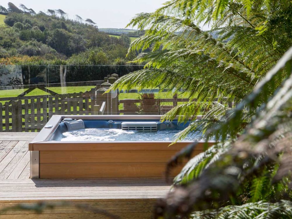 Hottub built into the decking at a holiday cottage at Tredethick.